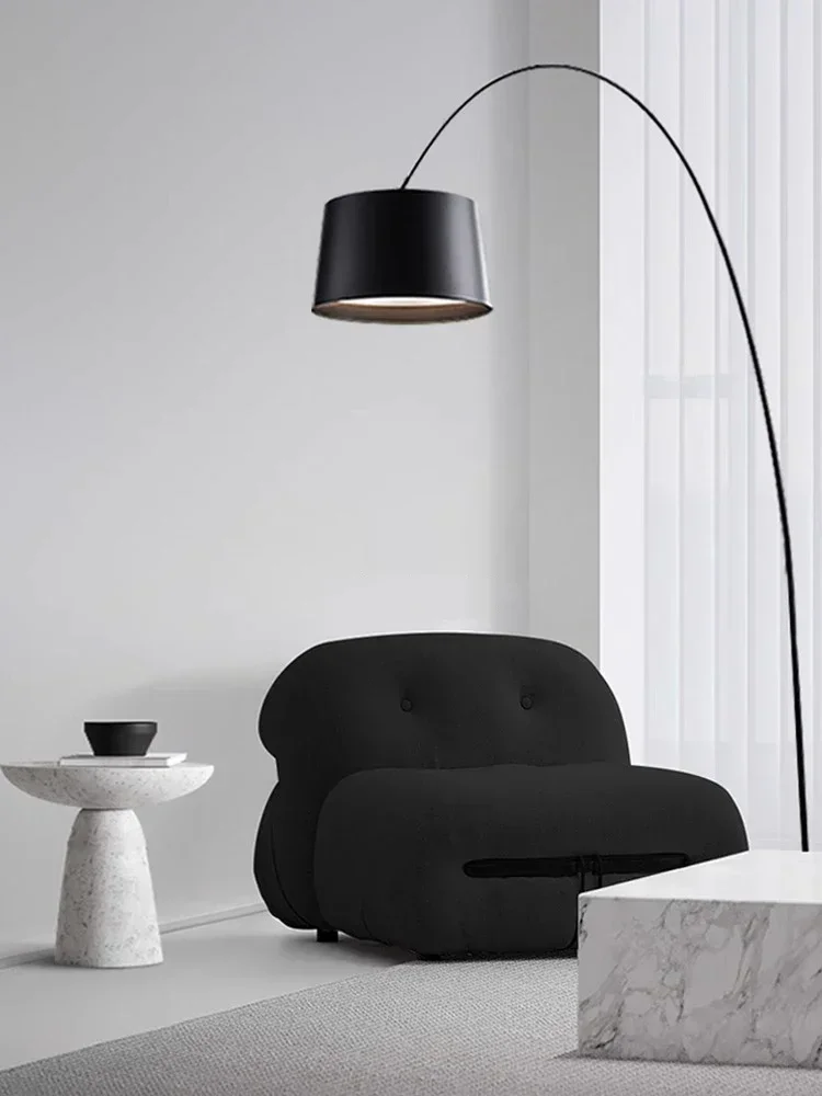 Contemporary arc floor lamp dramatically illuminating a room with soaring ceilings