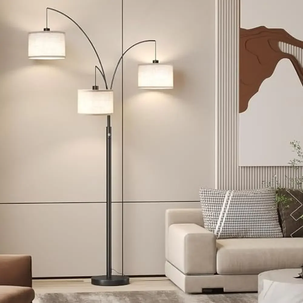 Modern three-light arc floor lamp harmonizing with contemporary furnishings in an open concept living space