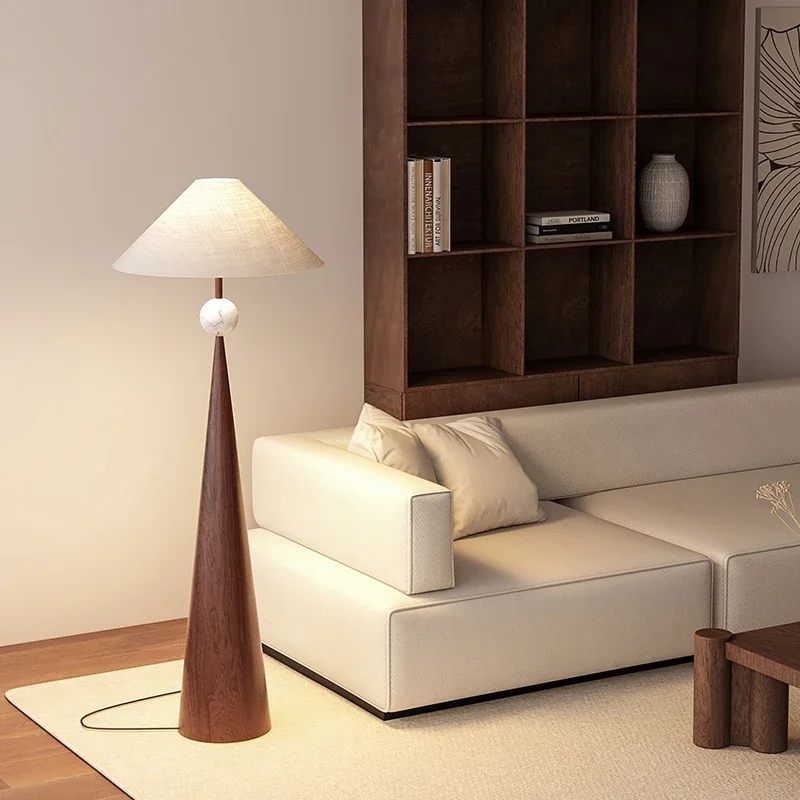 Contemporary arc floor lamp with fabric shade creating an intimate reading area in a warm interior