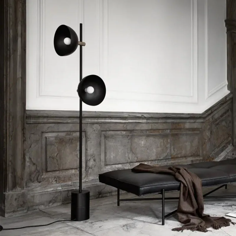 Contemporary arc floor lamp with elegant metal finish complementing high ceilings in an open living area